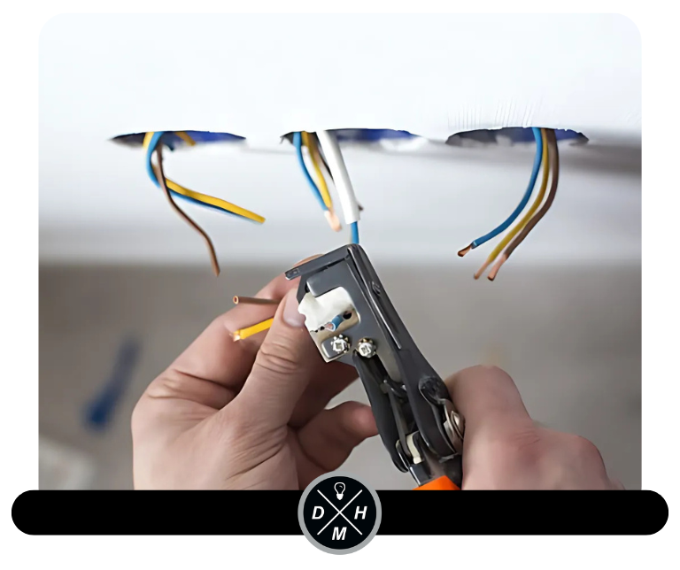 Electrician trimming wires coming out of ceiling